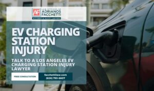 EV charging plug connected to a car with text reading EV Charging Station Injury and Talk to a Los Angeles EV Charging Station Injury Lawyer from the Law Offices of Adrianos Facchetti.