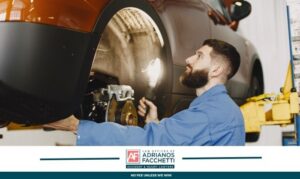 auto mechanic inspecting car brakes on lift