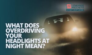 A vehicle driving on a dark road at night with headlights illuminating a limited stretch ahead, illustrating the concept of overdriving your headlights and the risk of nighttime car accidents in California.